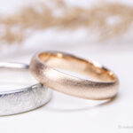 Handgefertigte Eheringe aus Gold und Silber mit individueller Oberflächenbearbeitung.